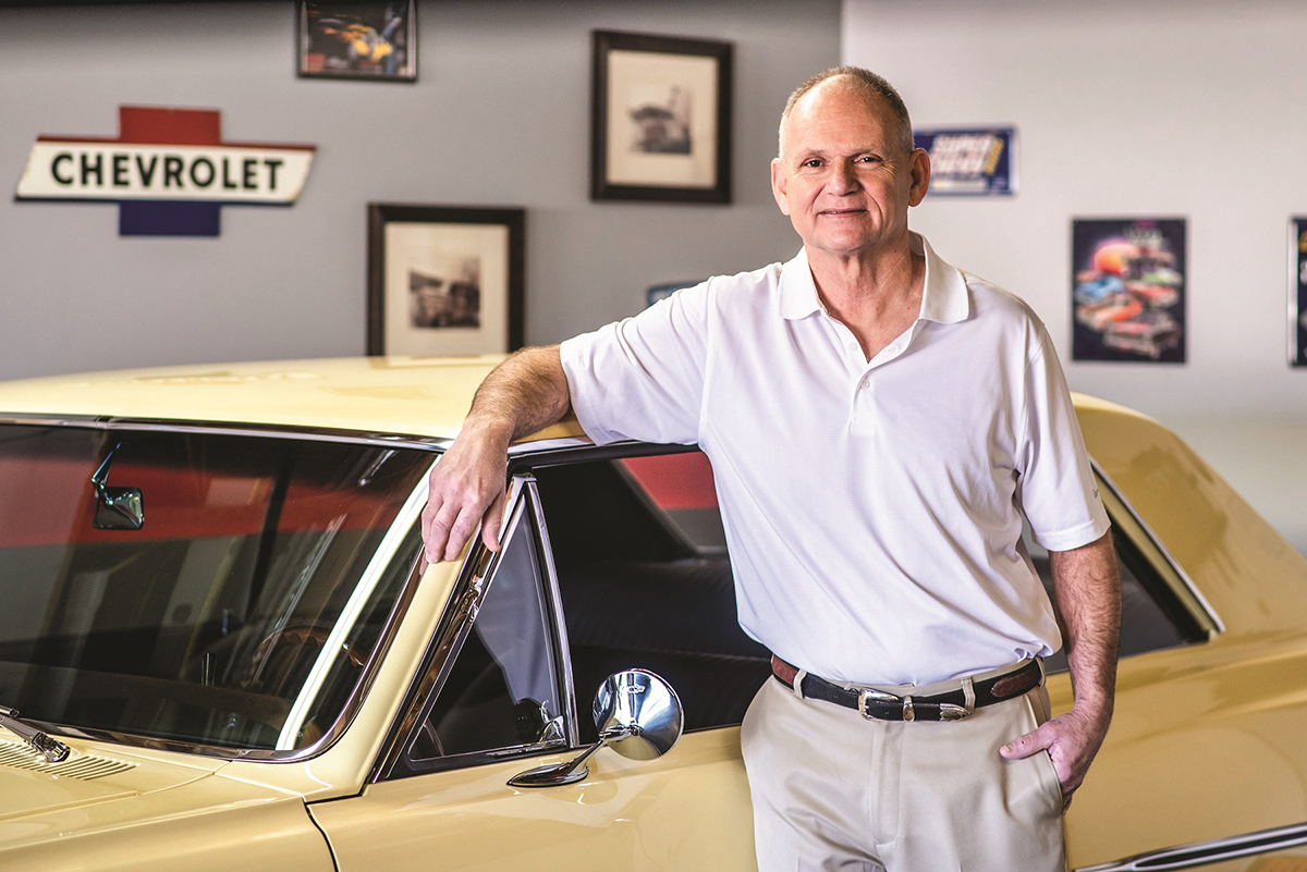 Man leaning by his yellow car