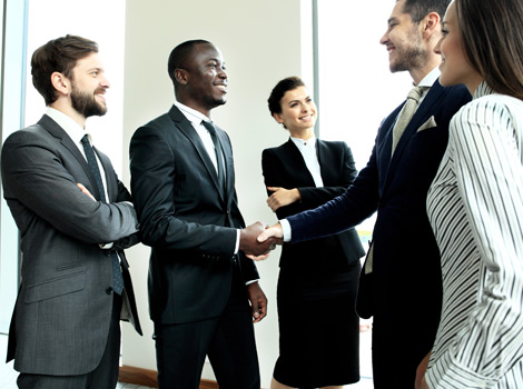 group of business men and women shaking hands
