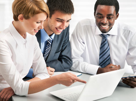 three people looking at a computer